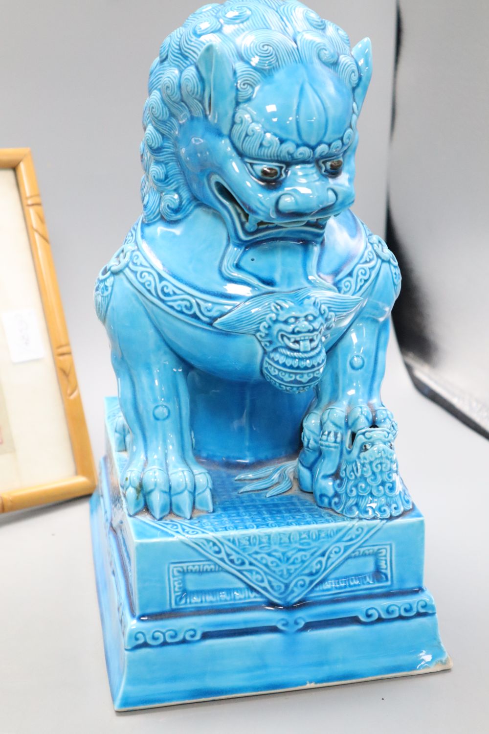 A turquoise glazed dog of fo, height 37cm and a silkwork